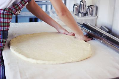 Midsection of woman preparing food in kitchen at home