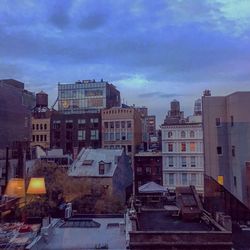 Buildings against cloudy sky