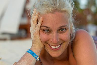 Close-up portrait of smiling young woman