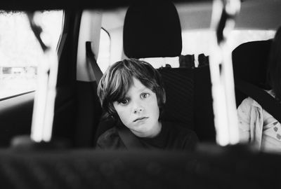 Portrait of boy sitting in bus