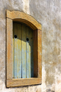 Low angle view of window on old building