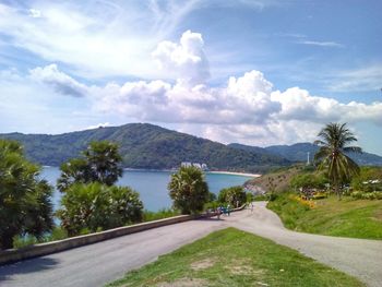 Road by mountains against sky