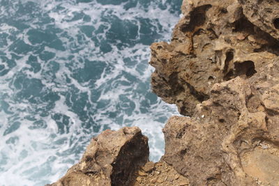 High angle view of rock formation in sea