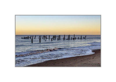 Scenic view of beach against clear sky