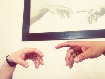 Close-up of hands over white background