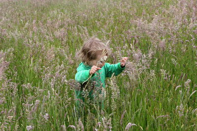Girl with flowers in field