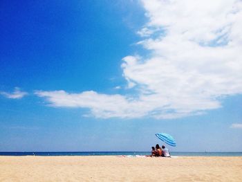 Scenic view of beach against cloudy sky