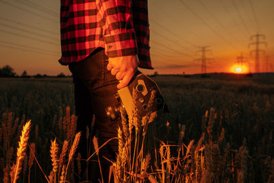 Low section of woman standing on field