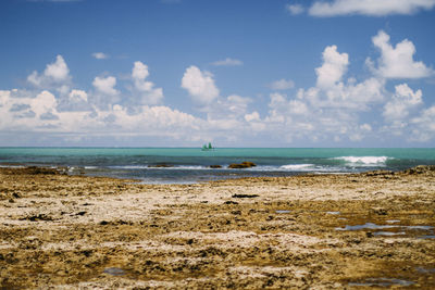 Scenic view of sea against cloudy sky