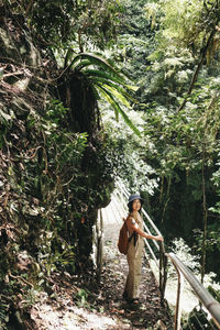 Rear view of woman walking on field