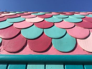 High angle view of multi colored umbrellas against blue sky