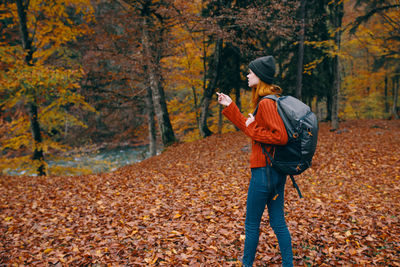 Man photographing with autumn leaves