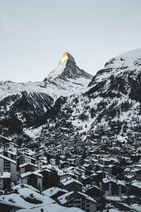 Scenic view of snowcapped mountains against clear sky