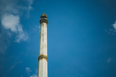 Low angle view of lighthouse against blue sky