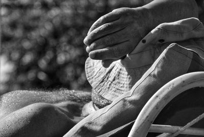 Close-up of man relaxing at beach