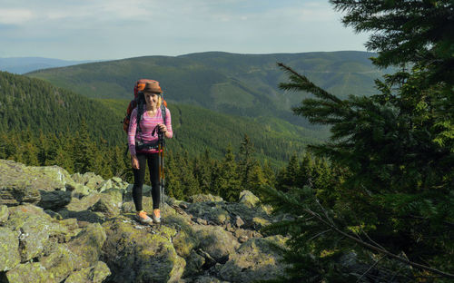 Rear view of woman standing on mountain