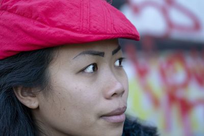Close-up of young woman wearing flat cap