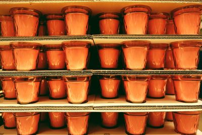 Full frame shot of candles on shelves for sale in store