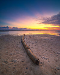Scenic view of beach against sky during sunset