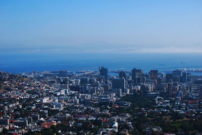 High angle view of buildings by sea against sky