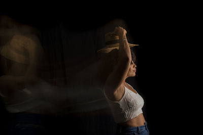 Time-lapse view of woman moving a hat. long exposure, motion blur. happy woman. salvador, brazil.