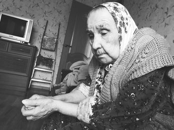 Portrait of smiling woman sitting at home