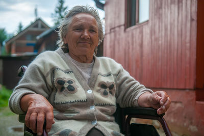 Portrait of mid adult woman sitting outdoors