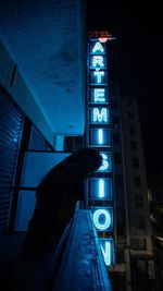 Low angle view of illuminated building against sky at night