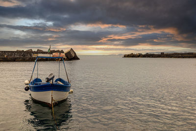 Details of a small sicilian fishing port. in the background stands the etna volcano