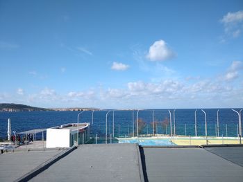 Scenic view of swimming pool by sea against sky
