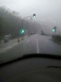 Raindrops on car windshield during rainy season