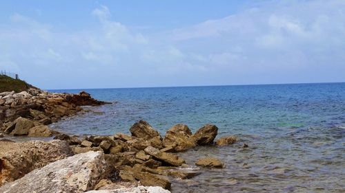 Scenic view of sea against cloudy sky