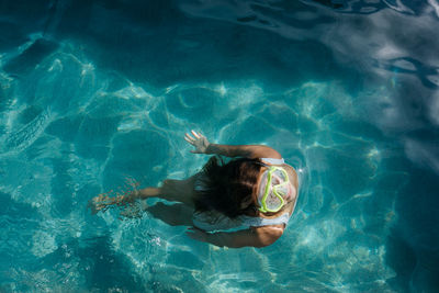 High angle view of woman swimming in sea