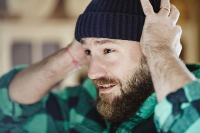 Man putting hat on