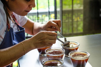 Midsection of woman making espresso