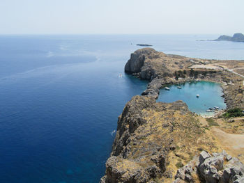 High angle view of rock formation in sea against clear sky