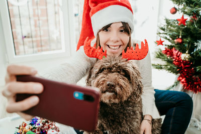 Portrait of smiling young woman using mobile phone