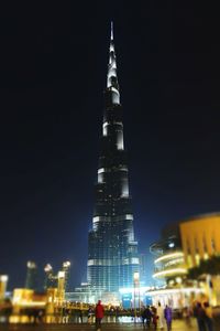 Low angle view of illuminated tower at night