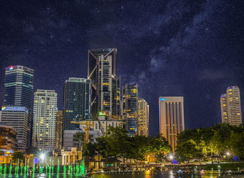 Illuminated city against sky at night