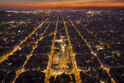 High angle view of illuminated cityscape against sky during sunset