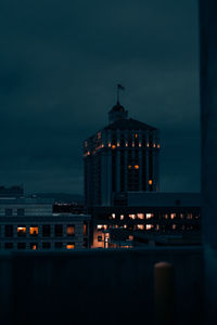 Illuminated building against sky at night