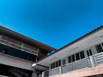 Low angle view of building against clear blue sky