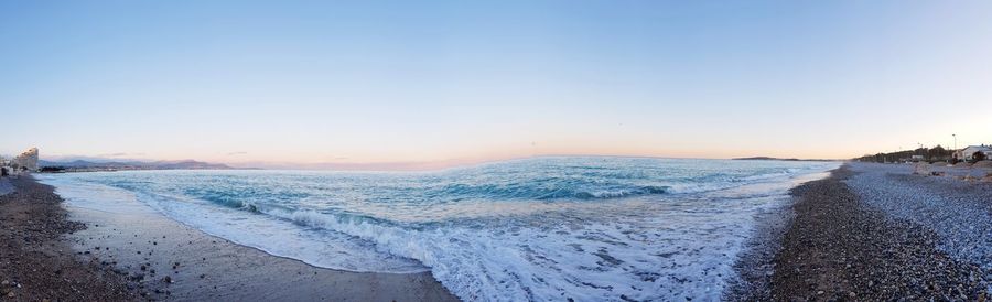 Scenic view of sea against clear sky during sunset