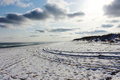 Scenic view of beach against sky during winter