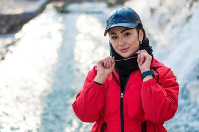 Portrait of young woman standing outdoors