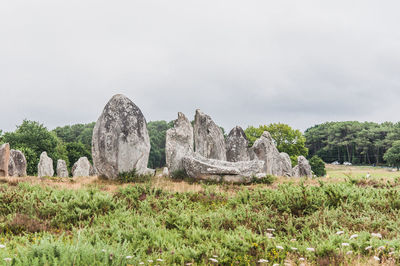 Panoramic view of rocks on field against sky