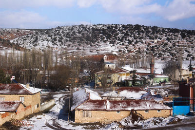 Aerial view of townscape against sky during winter