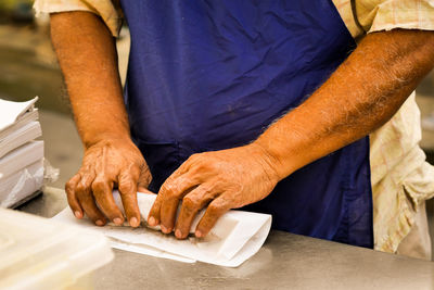 Midsection of man preparing food