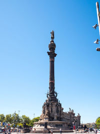 Statue of historic building against blue sky