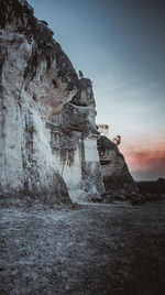 Low angle view of rock formations against sky